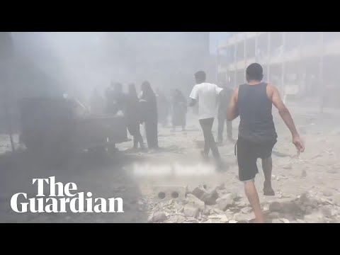 Survivors carried through dust after airstrike hits Gaza school housing displaced families