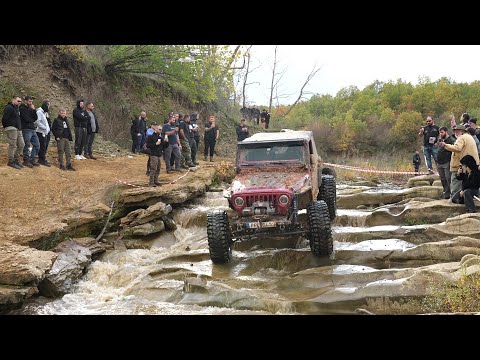 American jeep off roading in to river