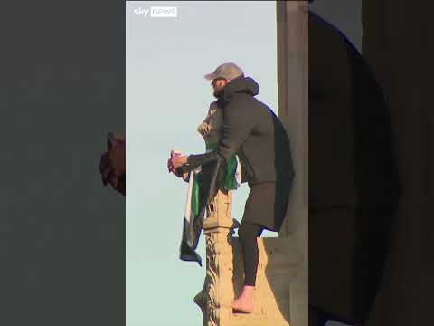 Police try to convince man who climbed Big Ben to come down