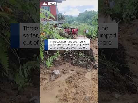 Landslide sweeps two buses into river