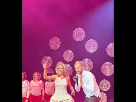 Konrad Laimer rapping with Shirin David on the stage at Bayern's celebration party