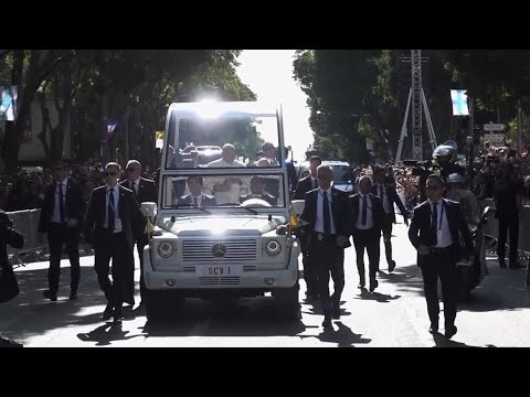 Crowds line streets in Marseille as popemobile carries pontiff to stadium Mass