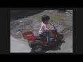 Chinese toddler drives on busy road on toy motorbike