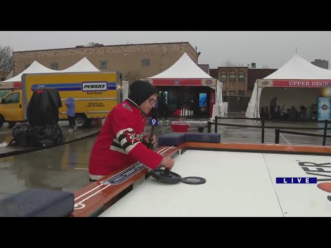 WGN's Erik Runge tries his hand at giant air hockey inside the NHL Winter Classic fan fest