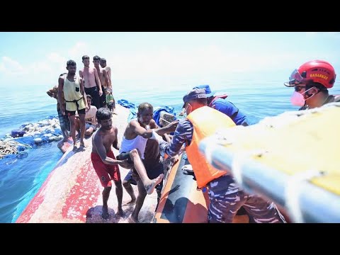 Dozens of Rohingya refugees rescued after night on hull of capsized boat