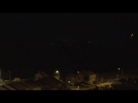 Flares and explosions over Gaza night sky as seen from across border in Israel