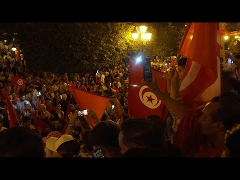 Supporters of Tunisian President Saied celebrate though official results yet to be announced