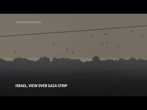 Aid drops into Gaza seen from south Israel; smoke seen from direction of Rafah at Gaza's Muwasi camp