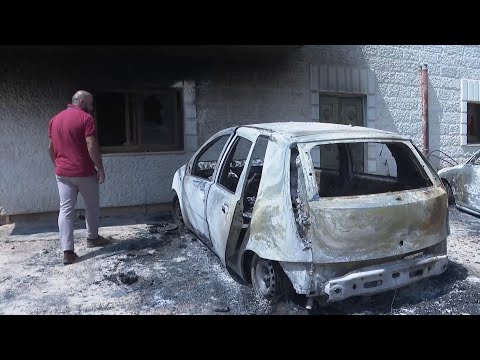Residents inspect burned cars and homes after Israeli settlers rampaged through village in West Bank