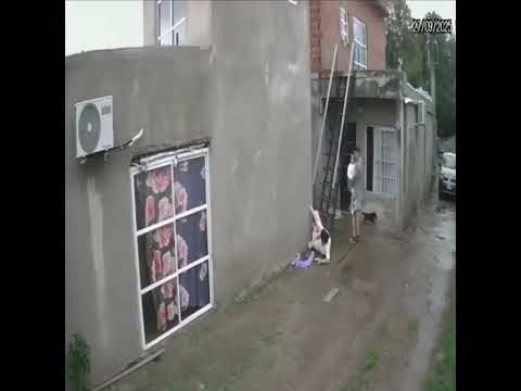 Woman Slips on Wet Metal Stairs and Slides to the Ground