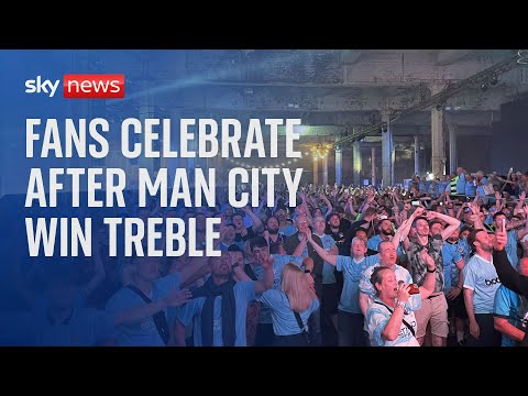 Fans celebrate after Manchester City win the treble