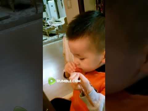 Adorable baby using chopsticks