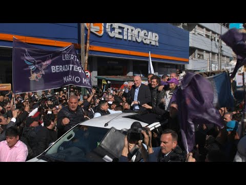 President Milei drives off as protesters throw objects at his vehicle during rally | AFP