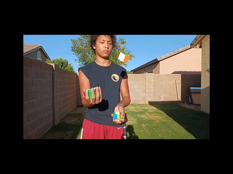 HE SOLVES 3 RUBIK'S CUBES WHILE JUGGLING