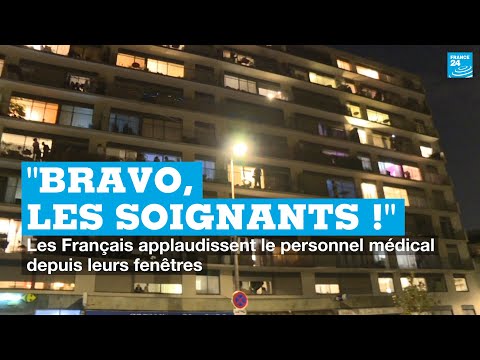 Des Français applaudissent le personnel soignant depuis leurs fenêtres
