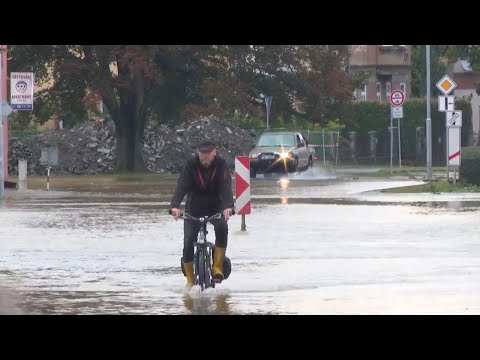 Vehicles drive through water as streets flooded in Litovel, Czech Republic