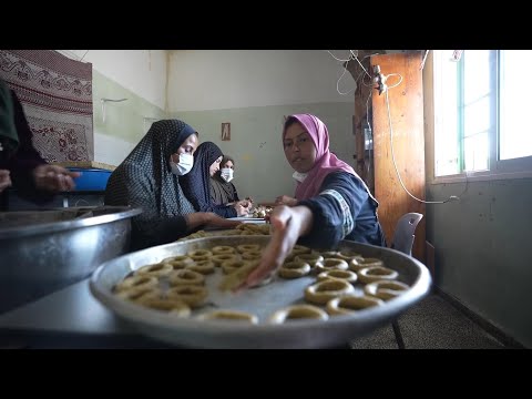 Displaced Palestinians bake cookies and sew clothes to mark Eid despite war