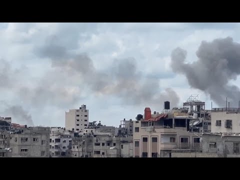 Smoke rises over buildings after Israeli jets launch airstrikes on Gaza City