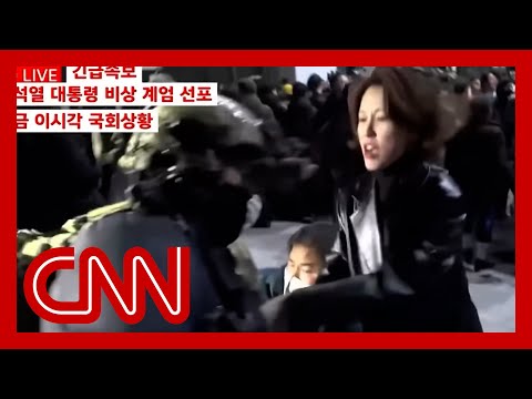 Soldier points rifle at lawmaker outside South Korean parliament