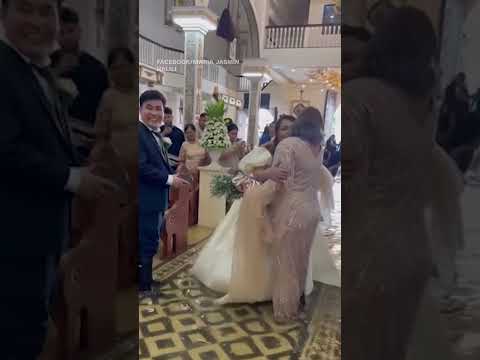 Bride walks down flooded aisle after Typhoon in the Philippines