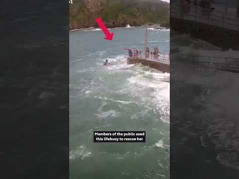 Moment girl swept into sea by giant wave