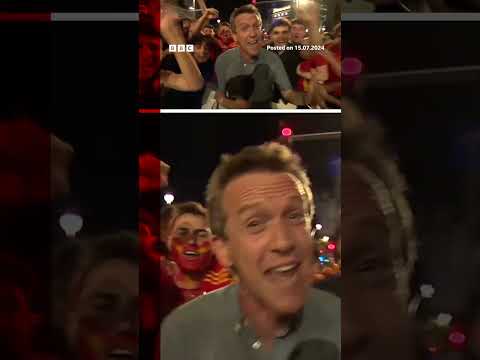 Cheering Spain fans surround BBC reporter live on-air after Euros win. #Euro2024 #BBCNews