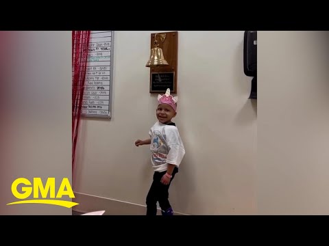 4-year-old girl walks down pink carpet to ring bell at end of cancer treatment