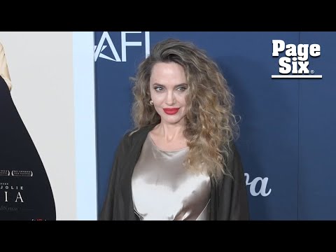 Angelina Jolie rocks wild curly hair and slinky dress at movie premiere