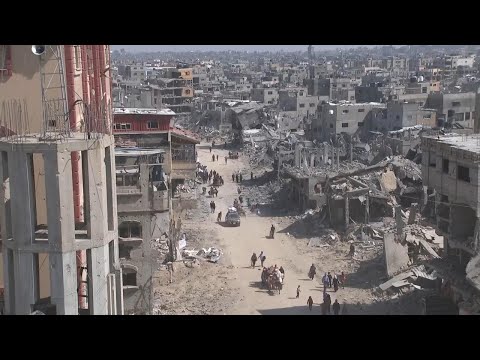 Hundreds walk by destroyed buildings in Khan Younis after partial withdrawal by Israeli army