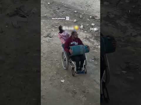 Video shows Gaza girl struggling to pull father’s wheelchair to transport gas cylinder