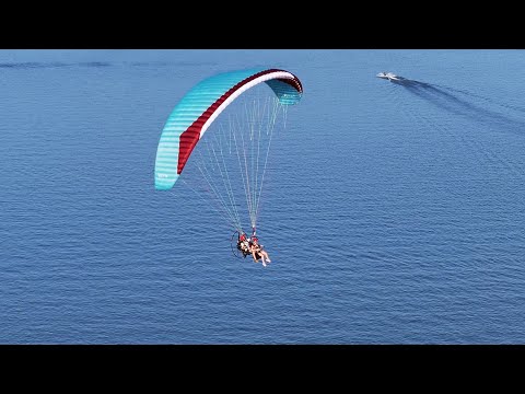 Paramotor gliding over the lakefront marina