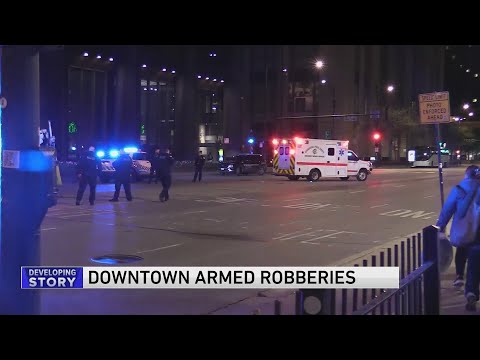 Woman dragged into street in string of armed robberies downtown; 3 men sought