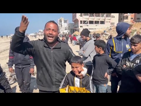 Hundreds wait amongst ruins of Gaza City for aid