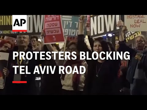 Protesters lock themselves in cages, blocking Tel Aviv road as they demand the release of hostages s