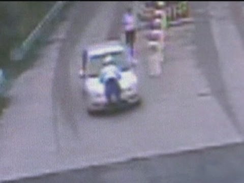 Car drives off with policeman on bonnet in China