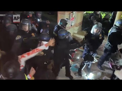 Police and protesters clash at UCLA in tense scene as pro-Palestinian encampment is dismantled