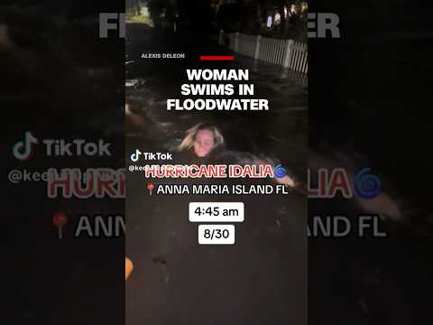 Woman swims in floodwater