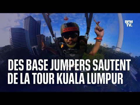 Des base jumpers sautent de la tour Kuala Lumpur en Malaisie