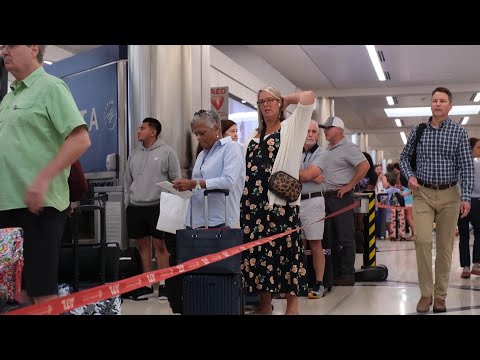 People wait in lines at Atlanta airport amid flight disruptions from global tech outage