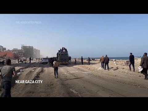 Palestinians race to collect food from aid convoy arriving in Gaza City