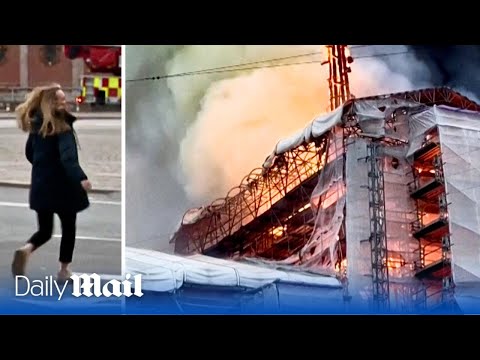Emotional woman attempts to enter Copenhagen's burning stock exchange