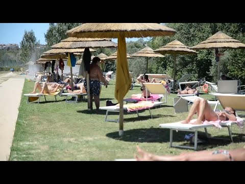 Artificial beach on banks of Rome's Tiber River delivers respite for 'staycationers'