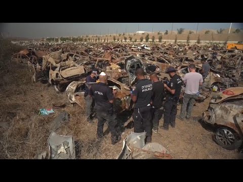 Survivors and salvage groups inspect vehicles damaged in Hamas attacks