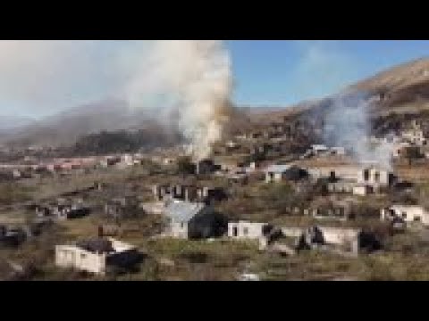 Fleeing Nagorno-Karabakh residents burn own homes