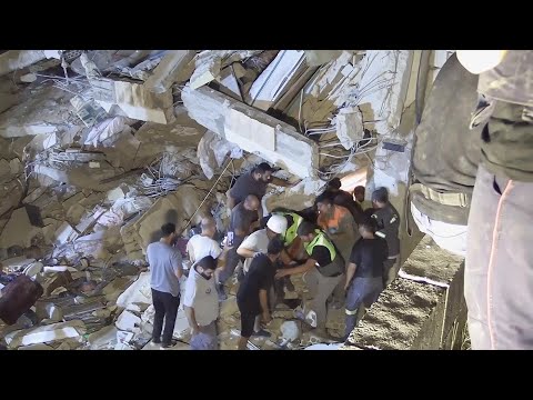 Rescuers in southern Lebanon pull survivor from rubble of building hit by Israeli strike