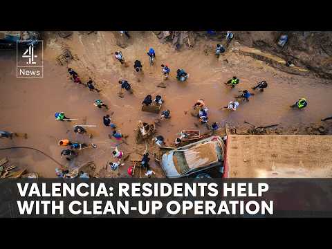 Spain floods: soldiers and army of volunteers work to clear wreckage