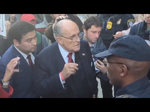 Giuliani blasts Biden on his way out of court
