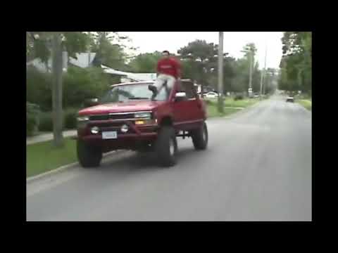 Guy Gets on Top of a Truck