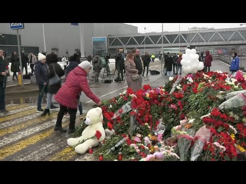 Flowers and tributes pile up outside Moscow concert hall as Russia mourns victims of terror attack