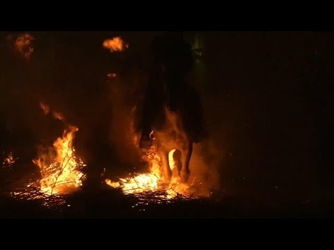Horses trot through bonfire flames in Spanish village's annual festival